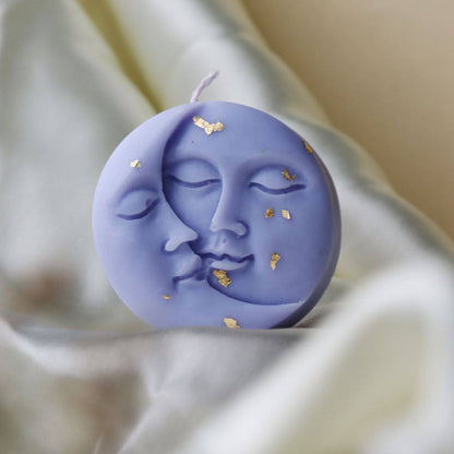 Moon Candle with celestial design, featuring a serene face and gold leaf accents. Perfect for an outdoor candle display and nature-inspired decor.