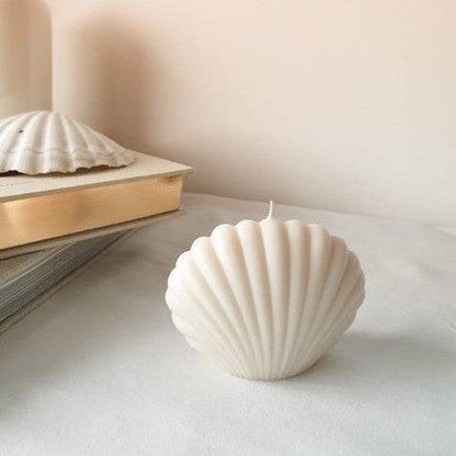 Shell Candle with a nature-inspired design, perfect for outdoor display. Elegant white seashell-shaped candle enhances home and garden decor.